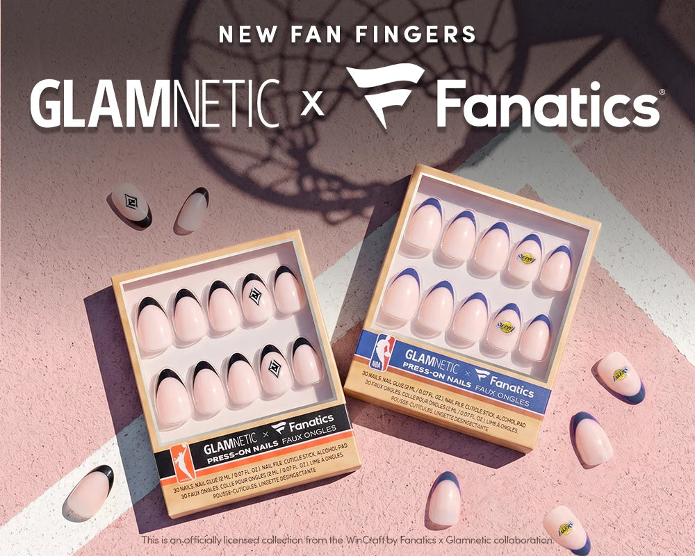 Two women show off manicured nails with sports-themed designs under a blue sky. The image promotes a Glamnetic x Fanatics collaboration with a 15% off offer for insiders.