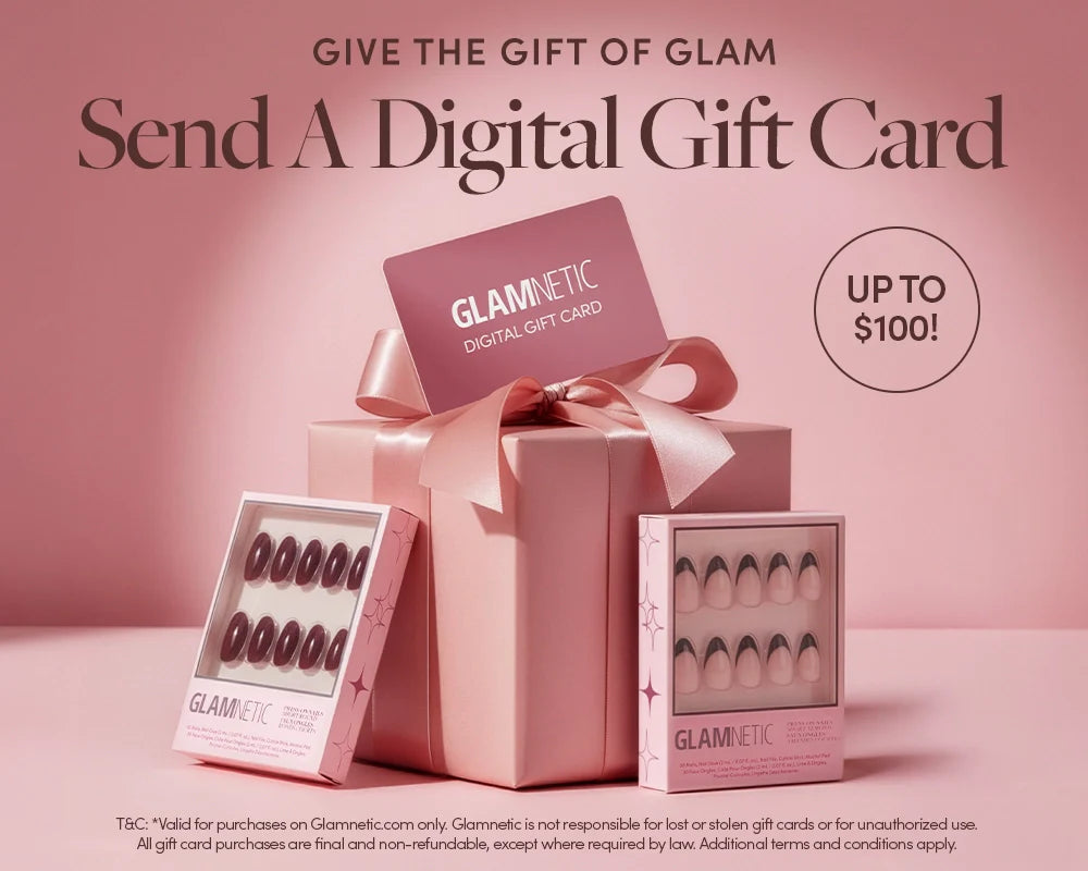 A pink gift box with a bow, a Glamnetic digital gift card, and two sets of Glamnetic press-on nails, with text promoting digital gift cards up to $100. The background is soft pink.