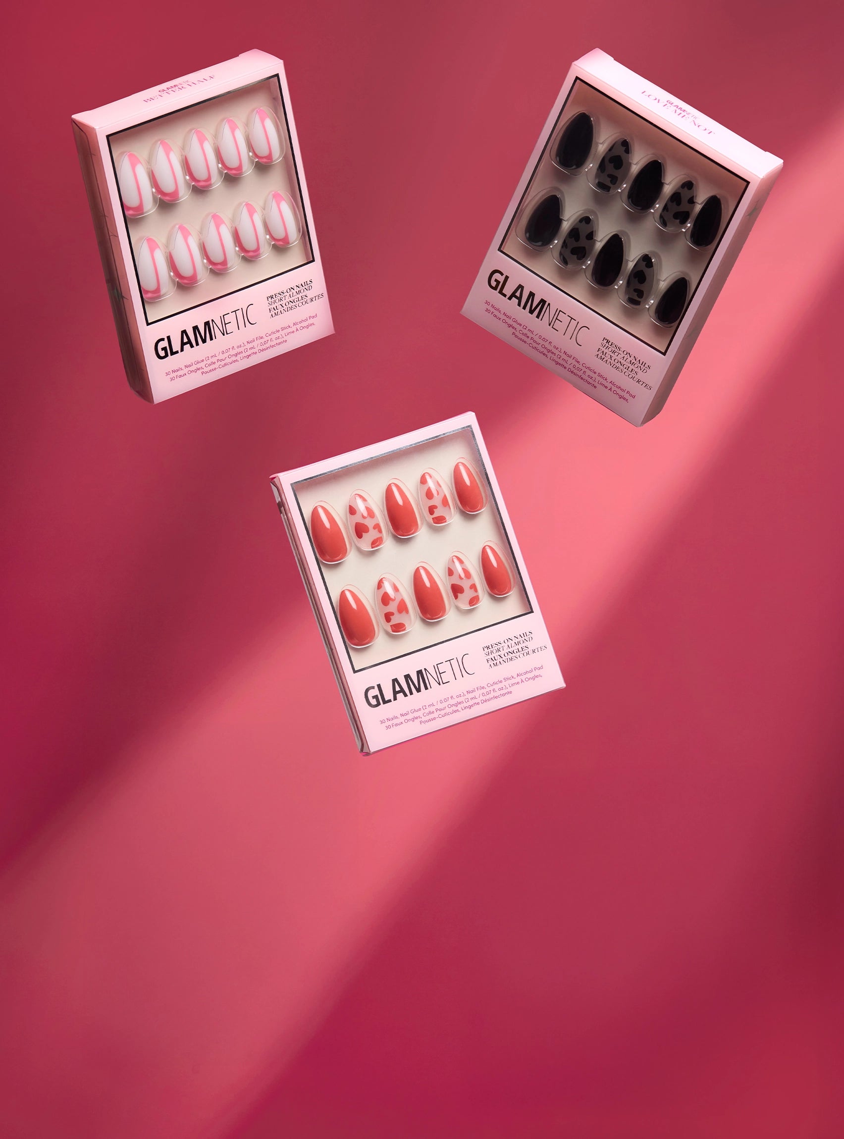 Three boxes of Glametric press on nails on a pink background