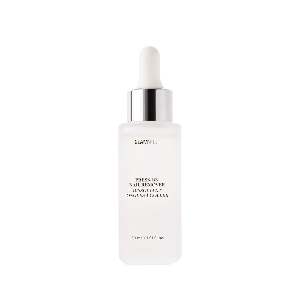 A frosted glass dropper bottle labeled glamnetic Press-On Nail Remover with a white dropper cap and silver collar. This acetone-free, vegan, and cruelty-free formula comes in a 30 mL (1.01 fl oz) size, shown upright on a white background. - Product image
