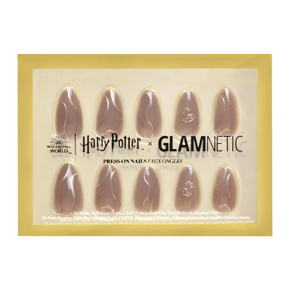 The Golden Cup™ Nail Set by glamnetic features ten nude-toned, almond-shaped nails with subtle lightning bolt designs in gold-edged packaging. The reusable nails come in a box with detailed branding and product information. - Product image