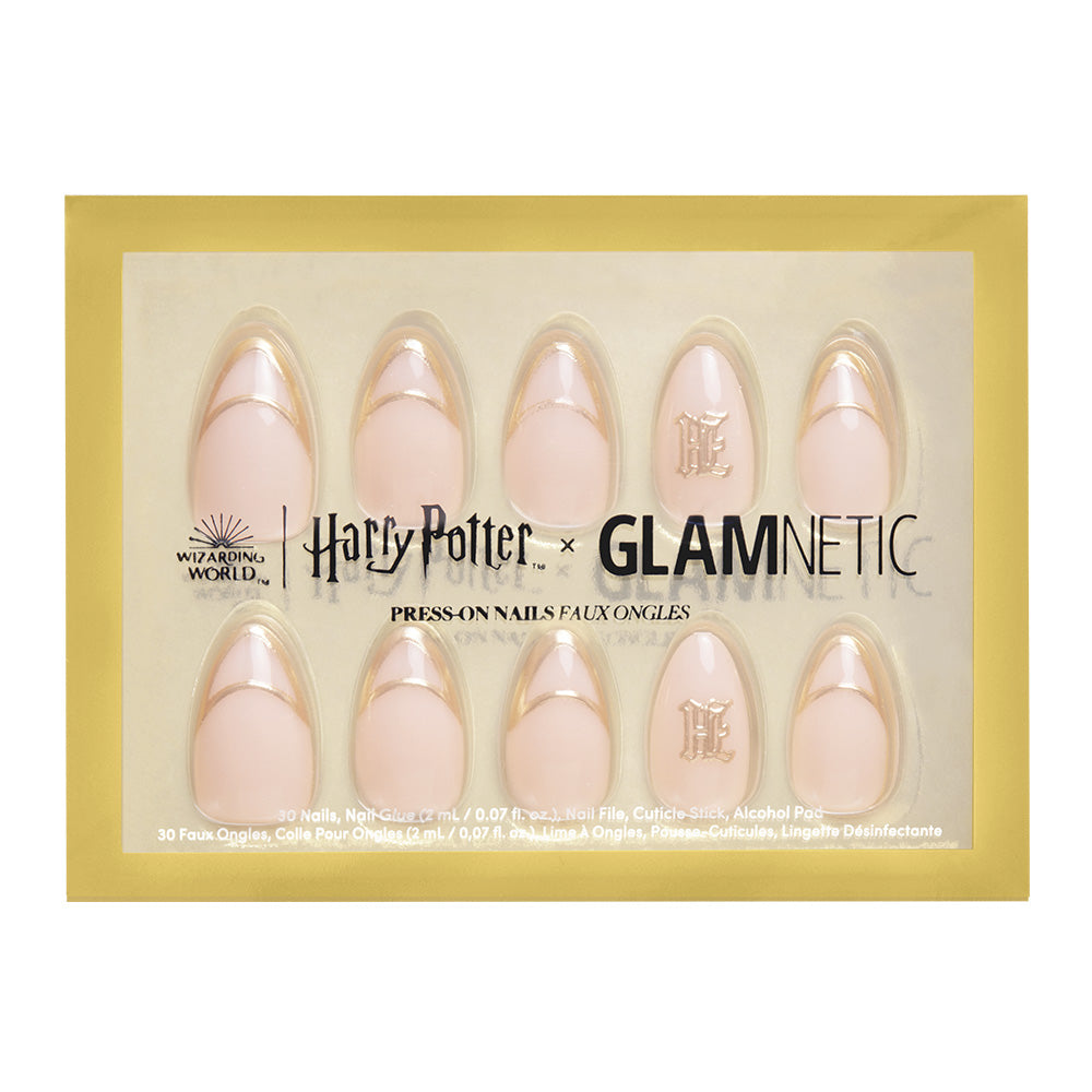 A set of glamnetic Hufflepuff™ press-on nails in a gold and clear package, featuring pale pink nails with gold tips, 3D gold foil accents, and nails with a gold H monogram from the Harry Potter collection.