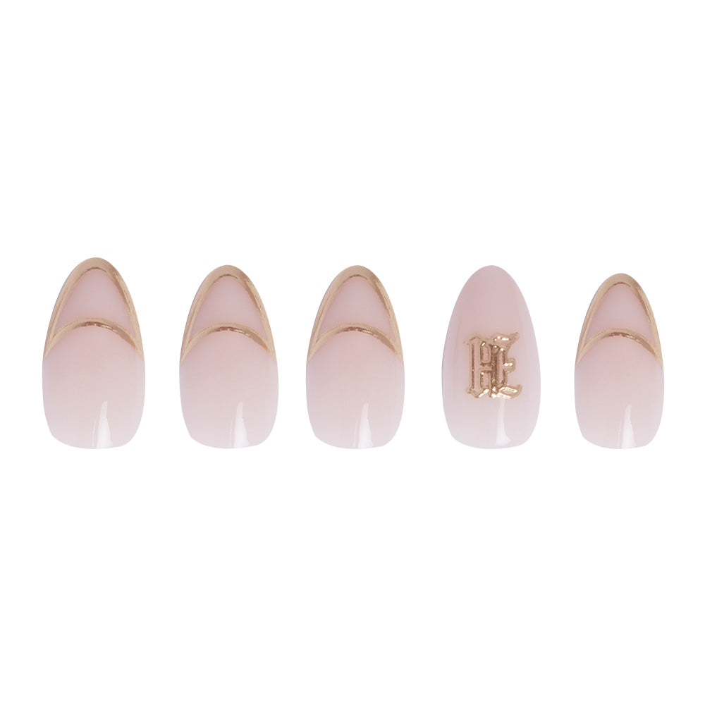 The Hufflepuff™ set by glamnetic features five nude oval-shaped vegan and cruelty-free false nails with gold French tips, including a 3D gold foil “E” accent, adding elegance to your manicure. - Product image