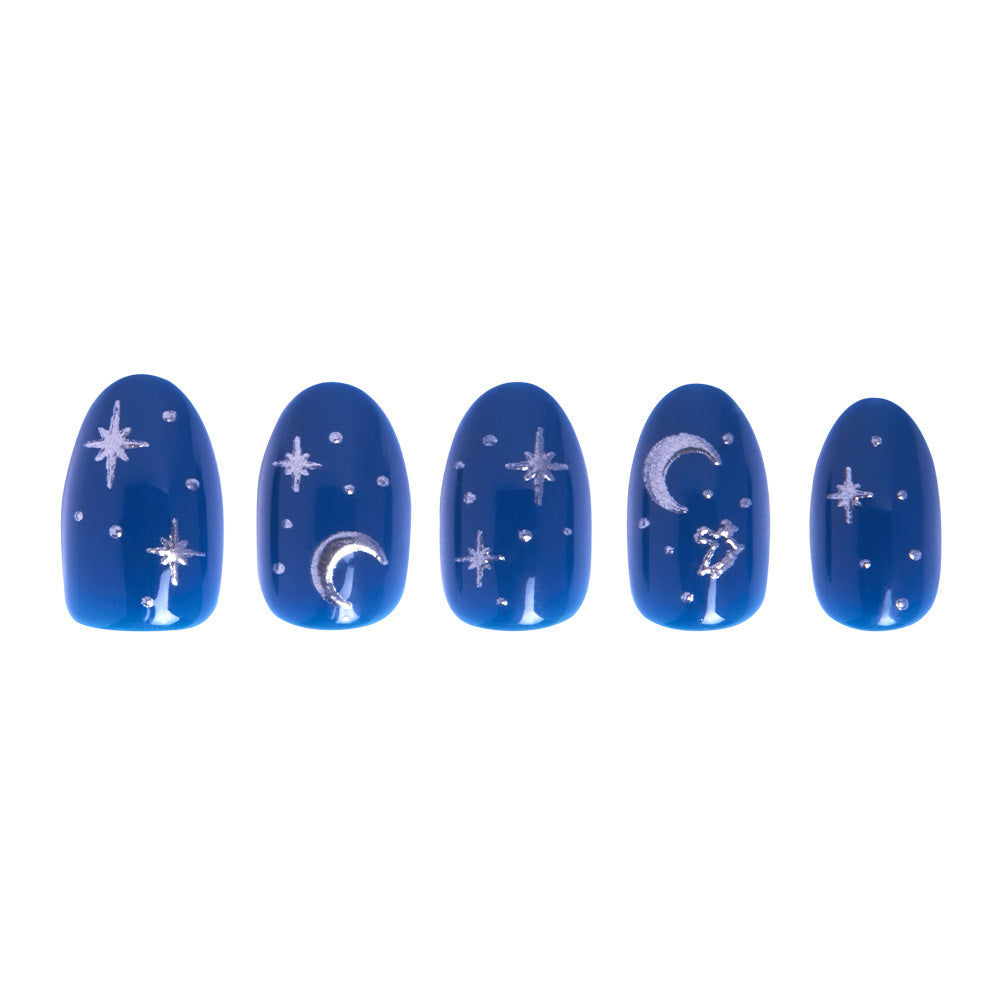 Five short oval Glamnetic Luna Lovegood™ nails, painted dark blue with white stars and crescent moons, are displayed in a row on a white background. Silver foil accents add sparkle to this enchanting celestial nail set. - Product image