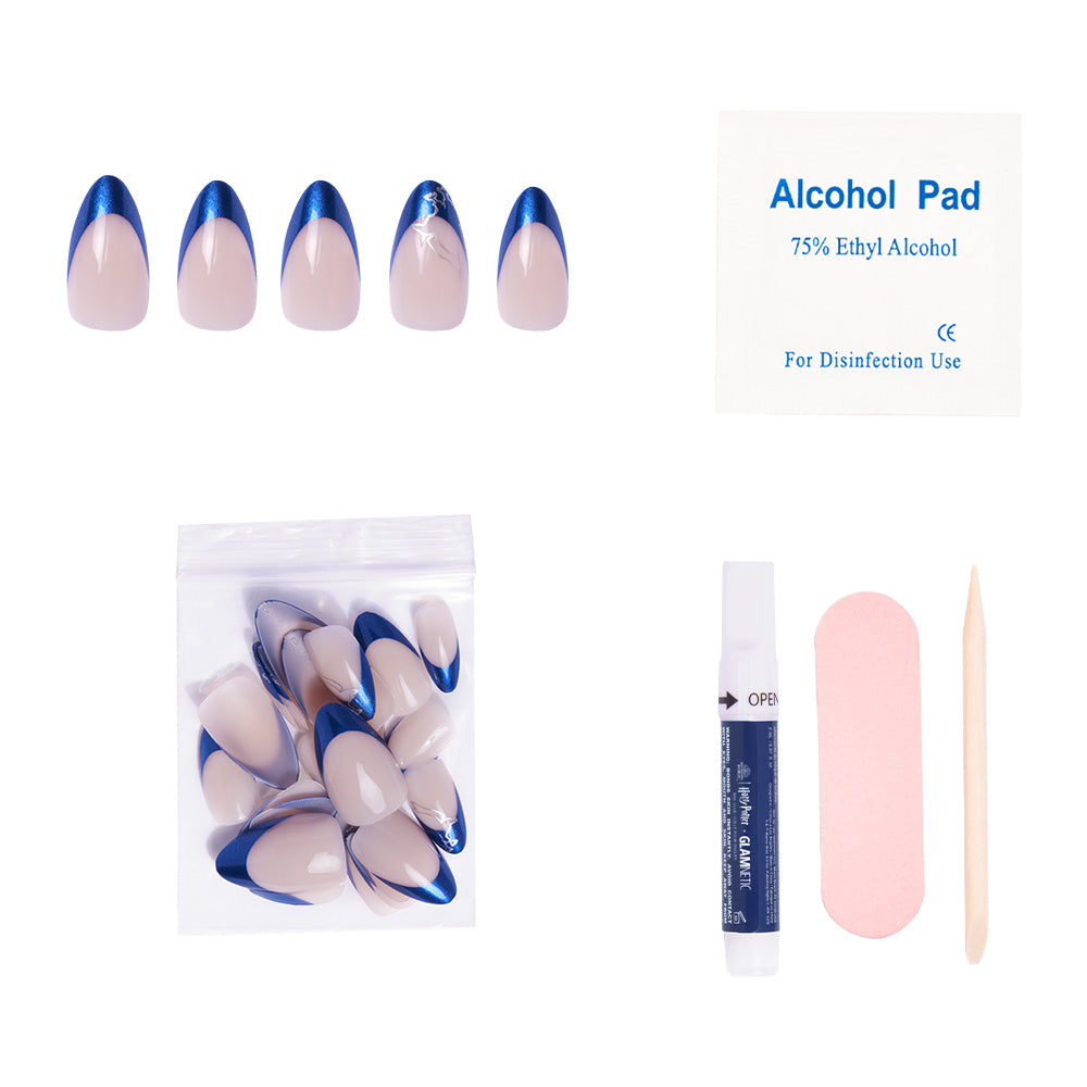 The glamnetic Ravenclaw™ press-on nail kit includes short almond nude nails with sapphire blue chrome tips, extra nails, nail glue, an alcohol pad, a pink nail file, and a wooden cuticle stick—displayed on a white background. - Product image