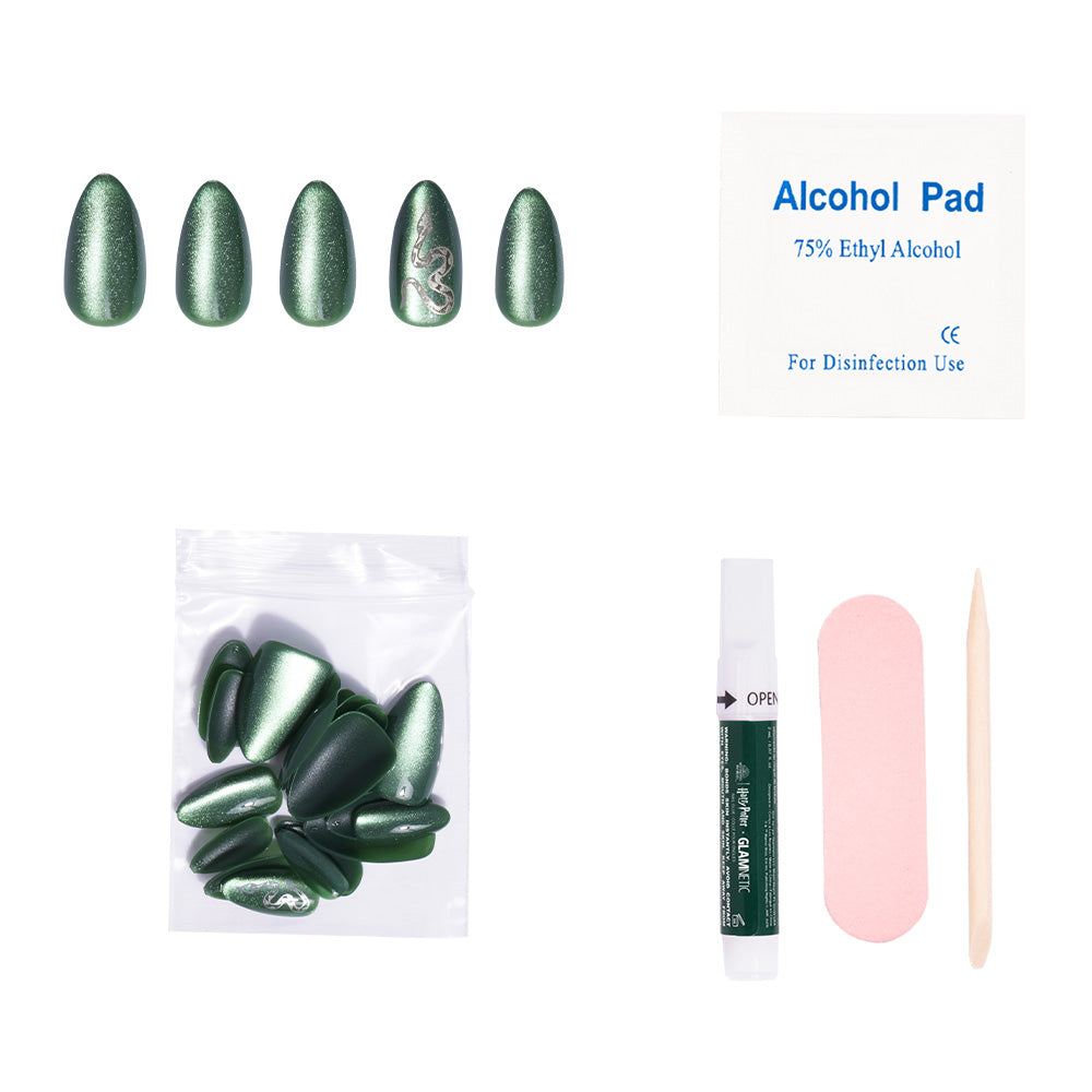 The glamnetic Slytherin™ set features emerald green press-on nails with a dragon design, plus an alcohol pad, adhesive tube, nail file, cuticle stick, and extra velvet-finish nails. - Product image