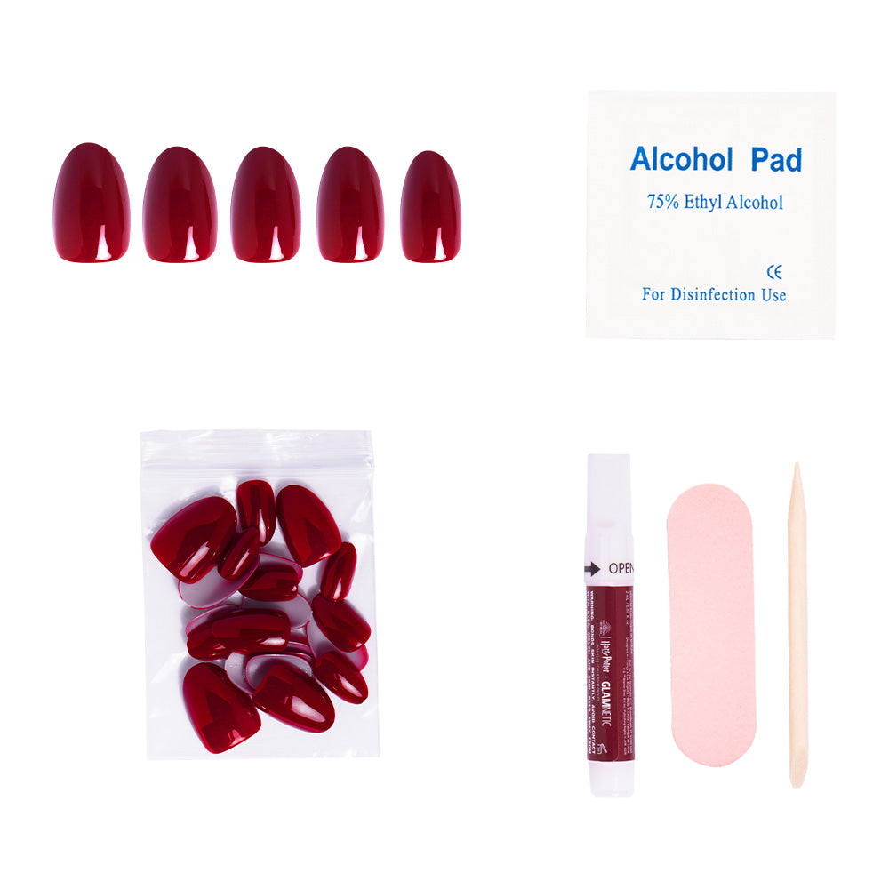 The glamnetic Marauders Map™ is a vegan, cruelty-free press-on nail kit featuring red nails, extra nails, glue, a nail file, alcohol pad, and cuticle stick—all artfully arranged on a white background. - Product image