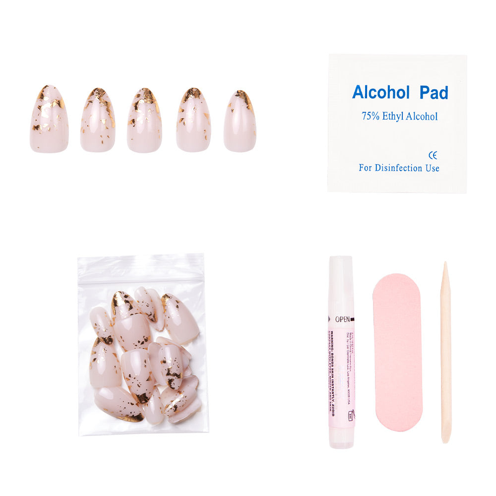 The glamnetic 24K set includes five short almond nails with gold foil accents, extra nails, nail glue, an alcohol pad, a pink nail file, and a wooden cuticle stick—all displayed on a white background. - Product image