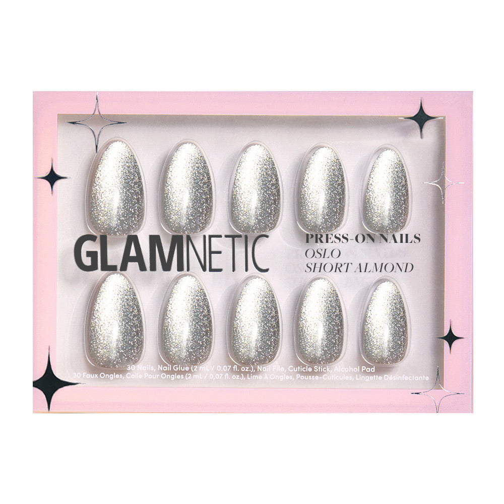 The glamnetic Oslo set features ten short almond-shaped silver glitter press-on nails, packaged in a pink box labeled Press-On Nails and Oslo Short Almond, with black star accents. - Product image