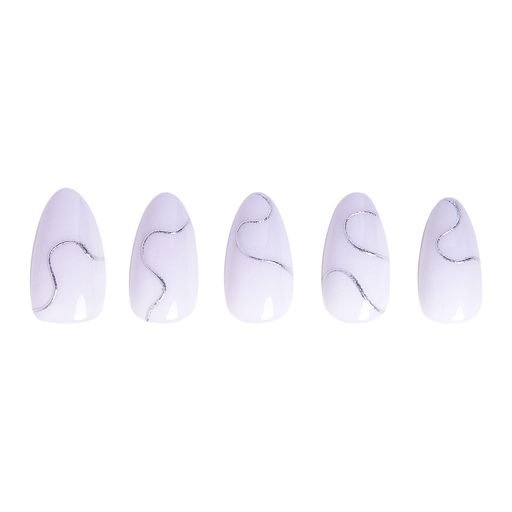 The Silent Night press-on nails by glamnetic feature five short, almond-shaped white nails with shiny silver wavy lines—an elegant winter style, beautifully arranged on a white background. - Product image