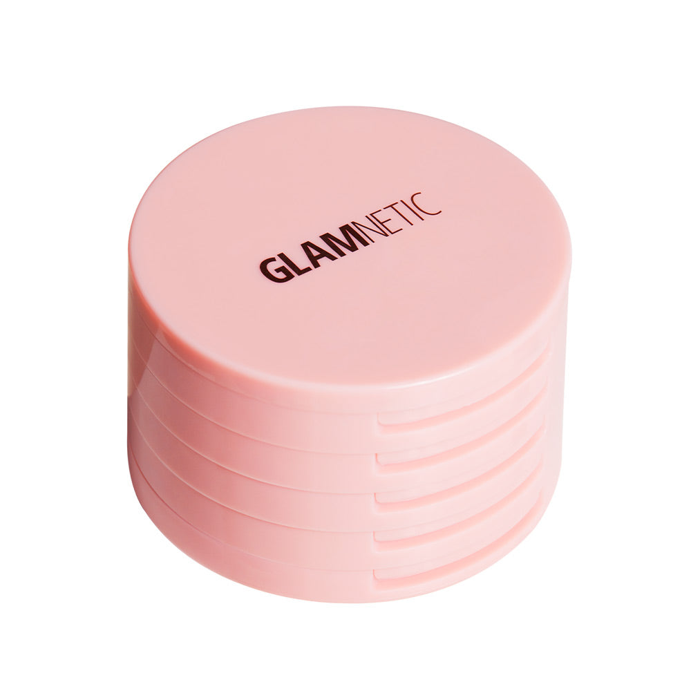 The Glam & Go Travel Case by glamnetic is a round, light pink container with glamnetic boldly printed on the lid. Its smooth sides have horizontal grooves—ideal for carrying your lash extensions or magnetic lashes on the go. - Product image