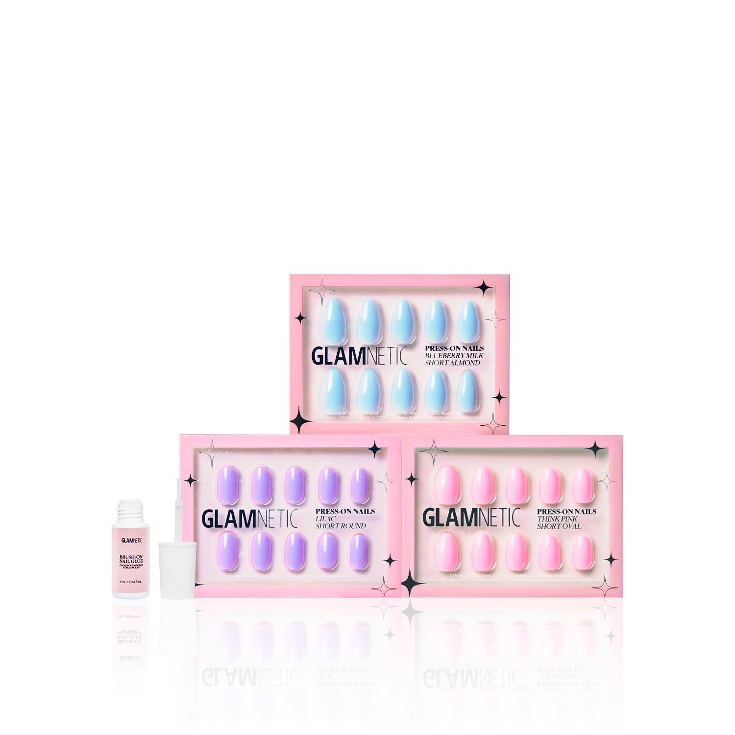 Three boxes of glamnetic Blooming Buds press-on nails are stacked in a pyramid, with a small bottle of nail glue on the left, all set against a white background. - Product image