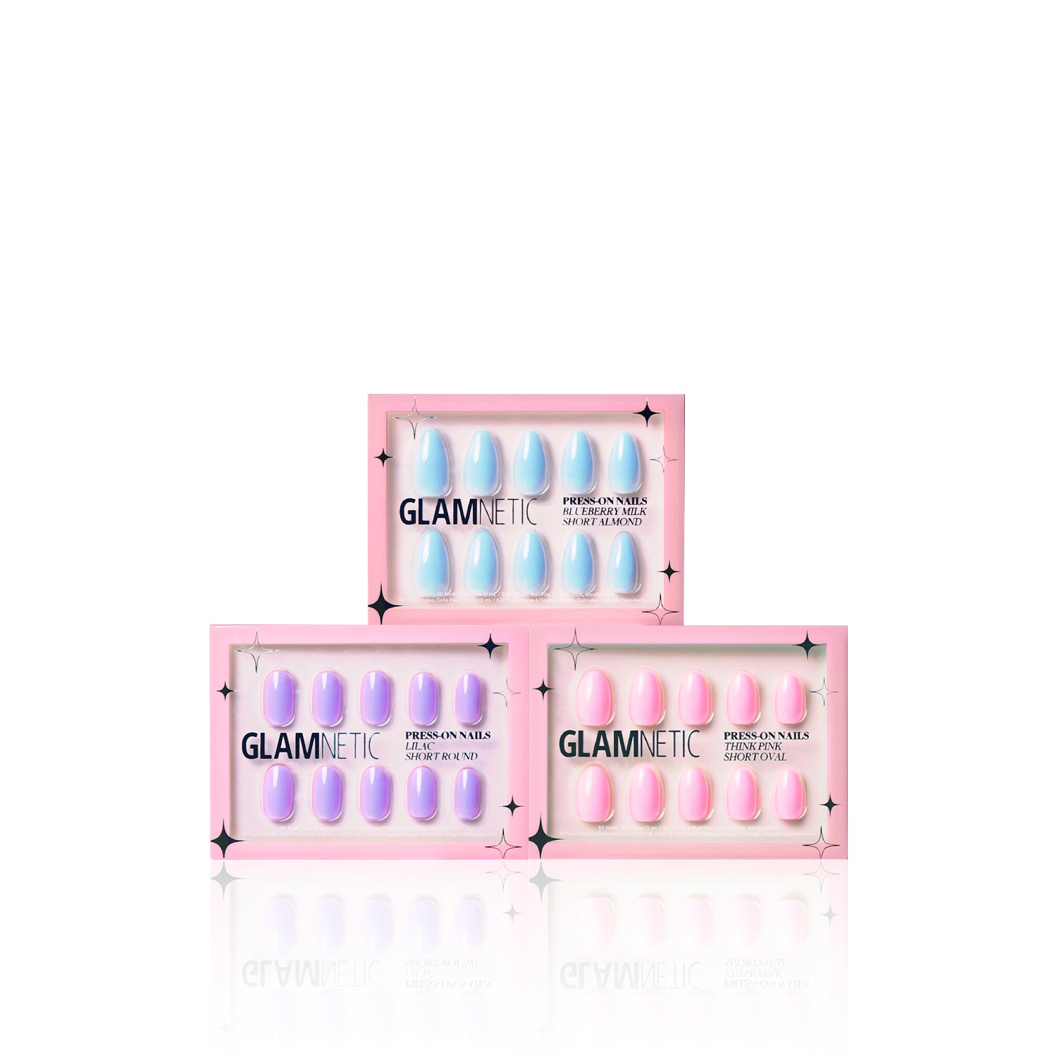 Three boxes of glamnetic Blooming Buds press-on nails are stacked in a triangle. Each box features a pink border and clear windows, revealing pastel shades for a playful pop of color. - Product image
