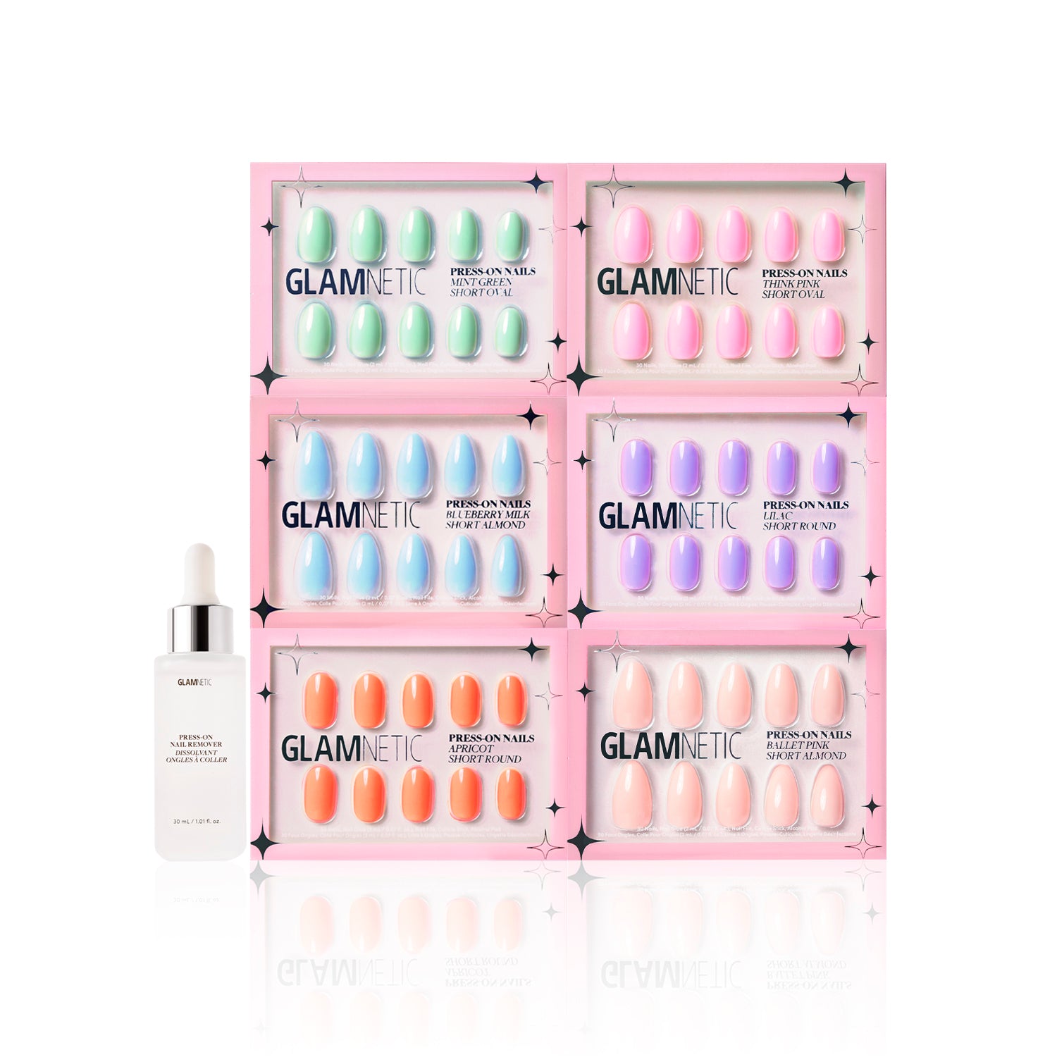 Six boxes of glamnetic’s The Solids: Spring Bloom Collection press-on nails in pastel shades are displayed in two rows, with a nail serum dropper bottle placed in front, all set against a white background. - Product image