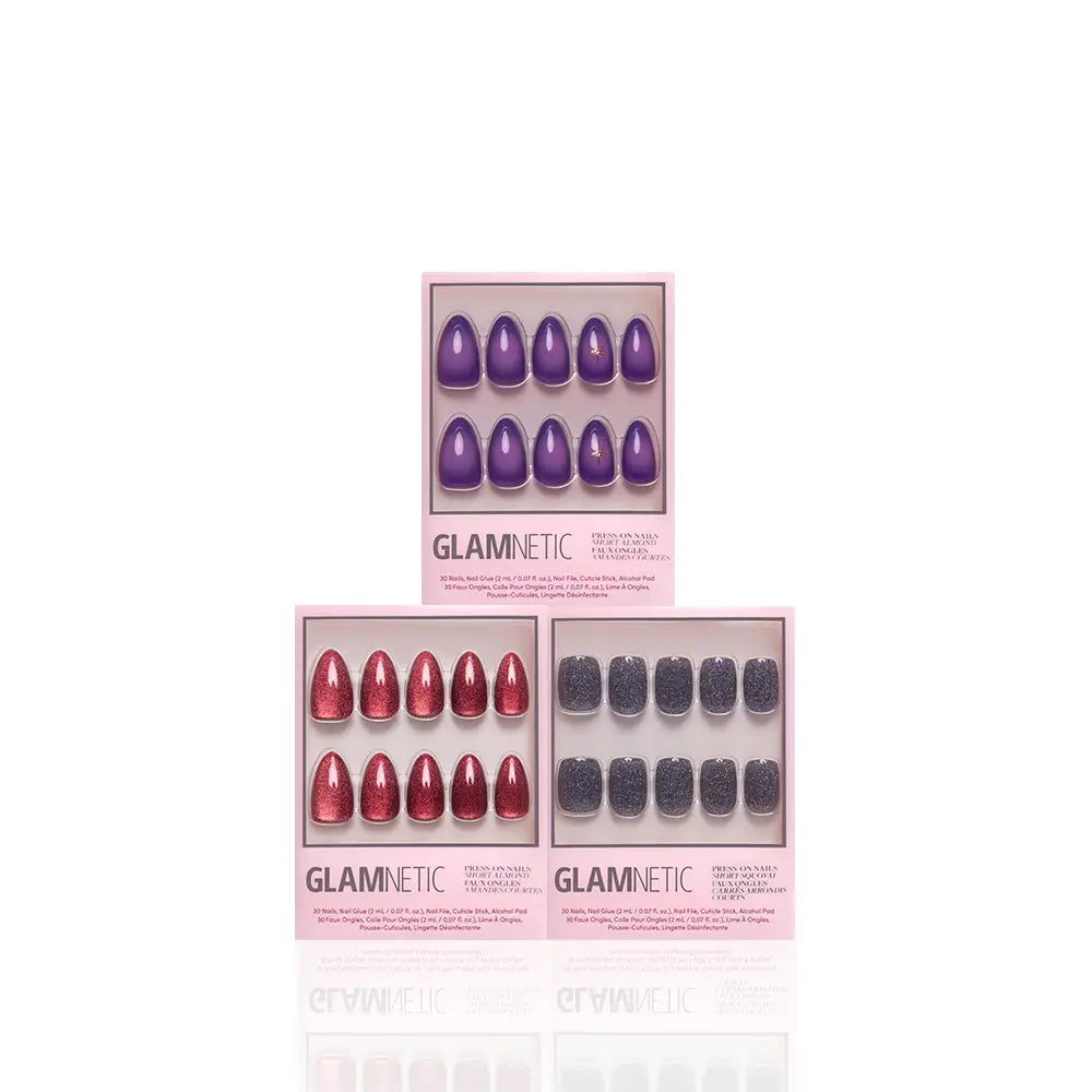 Three sets of glamnetic Mystic Vision vegan cruelty-free press-on nails in pink boxes: one set features a purple oval design, another showcases a red glitter oval style, and the third displays a black glitter square shape, all elegantly arranged against a white background. - Product image