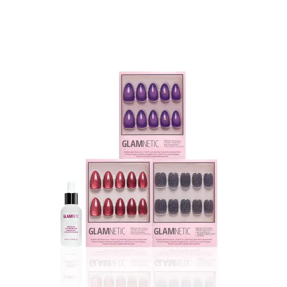 Three boxes of glamnetic Mystic Vision Press-On Nails—featuring chic Short Almond Nails in purple, red, and glittery black—are arranged in a triangle, with a dropper bottle of glamnetic Cuticle Oil placed in front against a white background. Enjoy salon-quality, vegan, cruelty-free nails from the comfort of home. - Product image