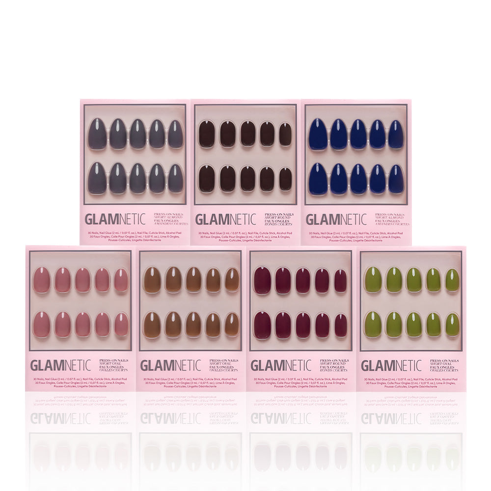 Eight boxes of glamnetics The Solids Vol.3 Fall Forest Collection press-on nails are arranged in two rows, displaying trendy fall shades like black, nude, blue, brown, burgundy, and green on a white background. - Product image