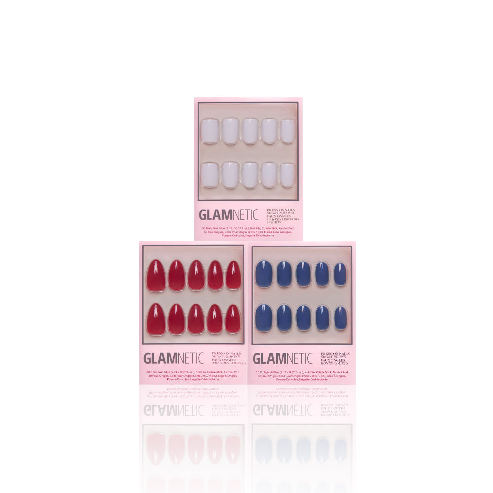 Three pink Glamnetic Royal Decadence press-on nail boxes are arranged in a triangle on a white background, with Lilac Gray at the top, Classic Red bottom left, and Regal Blue bottom right. - Product image