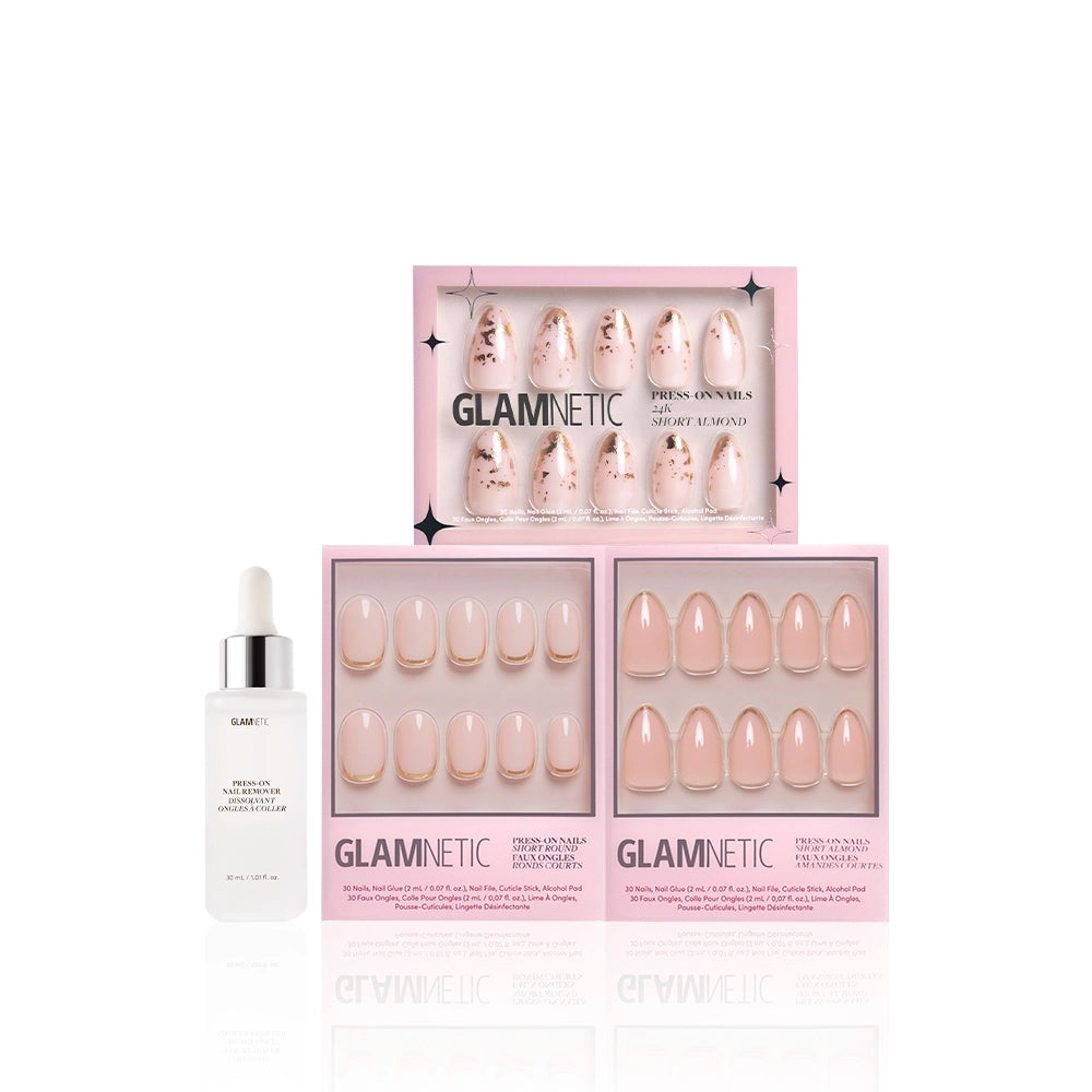 The glamnetic Golden Goddess bundle includes press-on nails in nude and pink designs with gold foil accents, plus a white dropper bottle with a silver cap, all presented in pink boxes on a white background. - Product image