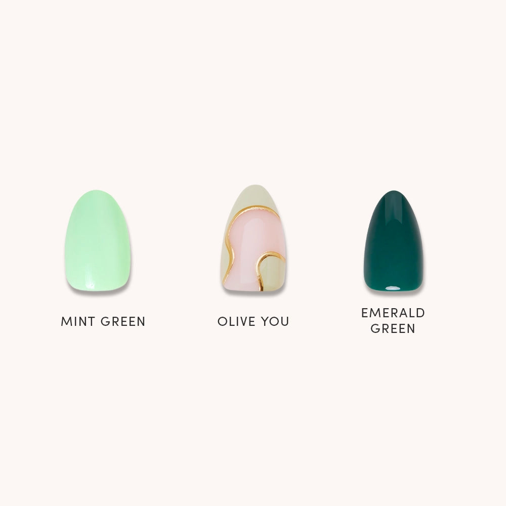 Green Enchantment by glamnetic features three press-on nails: mint green, abstract olive and gold swirl on nude, and emerald green. These salon-quality nails are color-labeled for easy use. - Product image