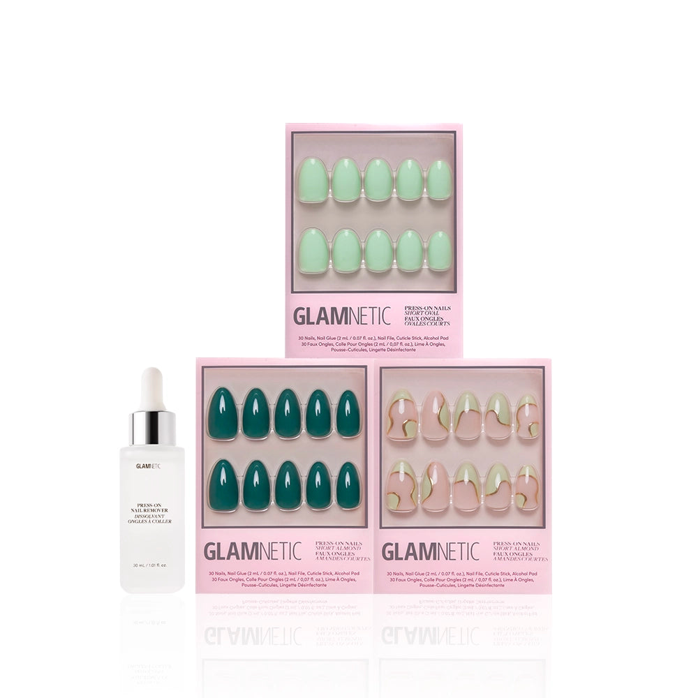 Three boxes of glamnetic press-on nails, including the Green Enchantment set, are displayed above a white glamnetic cuticle oil bottle with dropper on a white background. Experience salon-quality durability in each set. - Product image