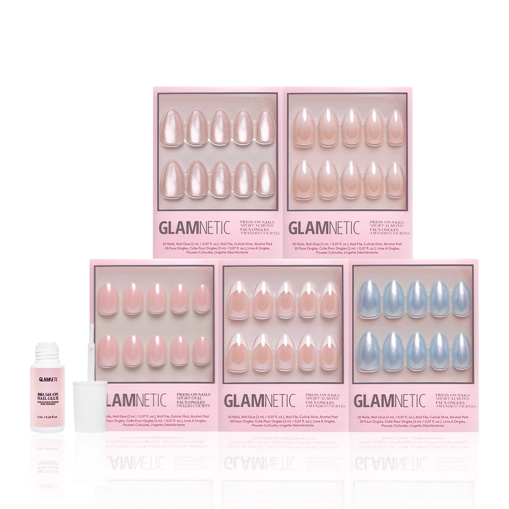 Five boxes of glamnetic Forever and Always press-on nails in pastel shades are arranged in two rows. A small bottle of glamnetic nail glue and an applicator sit to the left, with pink and clear packaging showcasing these modern designs. - Product image