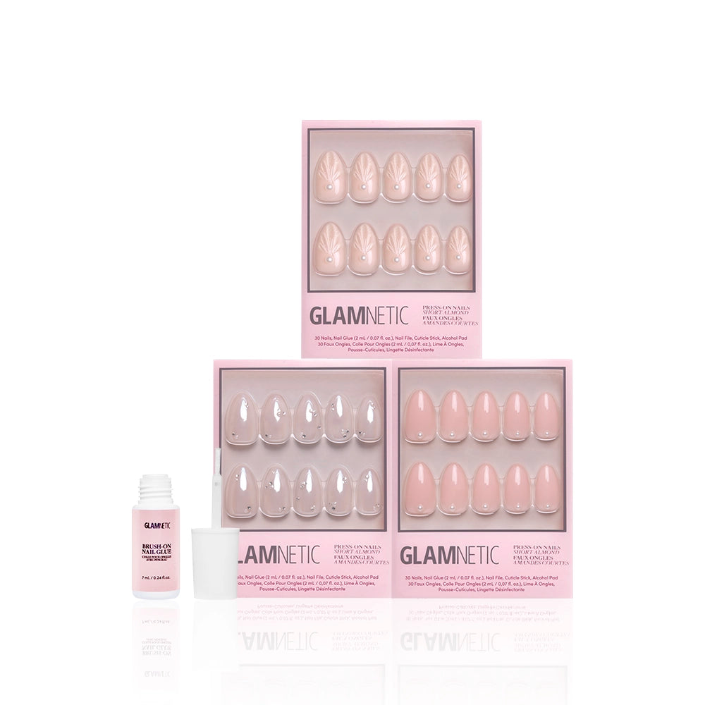 Three boxes of glamnetics Put A Pearl On It press-on nails are stacked, each featuring a unique glossy design. An open white nail glue bottle is placed beside the boxes, all set against a white background. - Product image