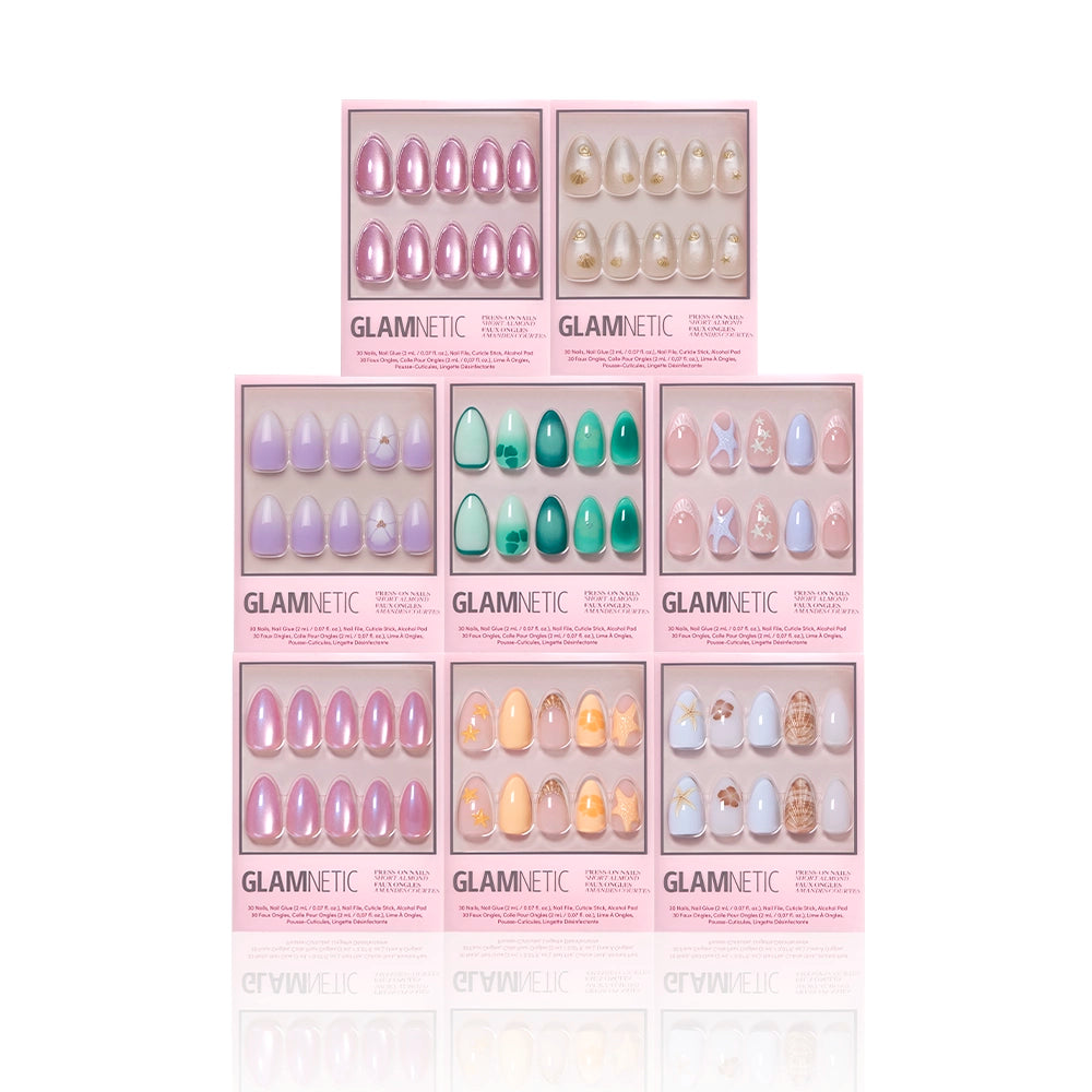Nine boxes of glamnetic’s Almonds At Sea press-on nails are arranged in a grid, each featuring short almond shapes with ocean-inspired designs, pink packaging, and playful 3D starfish accents. - Product image