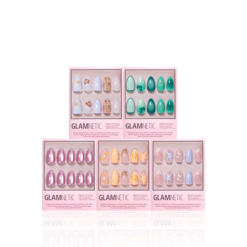 Five boxes of glamnetic’s Ann’s Cove press-on nails are arranged in two rows. Each pink box displays colorful nails with 3D art, pastel, floral, marble, and shiny designs in various shapes. - Product image