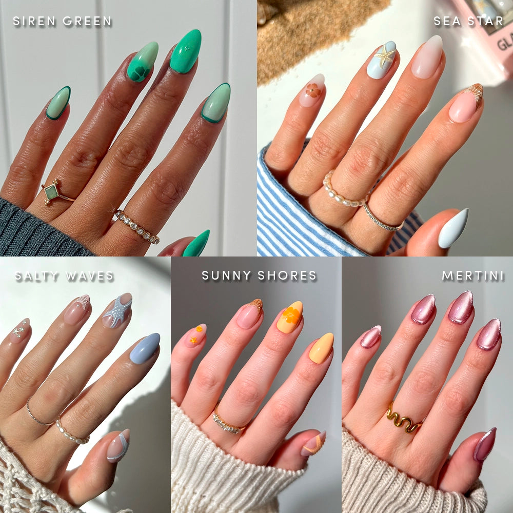 Six hands display glamnetic’s Ann’s Cove press-on nails, featuring pastel hues, shiny patterns, hints of 3D nail art, and gold rings—all inspired by coastal scenes—set against neutral backgrounds.