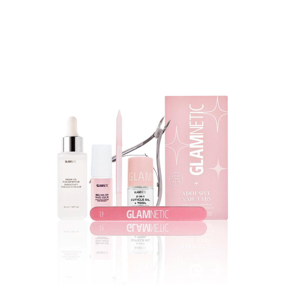 The glamnetic Mani Maintenance Kit in pink includes a nail file, cuticle oil, trimmer, buffer, a small pink box, and manicure tools—all cuticle care essentials neatly showcased on a white background. - Product image