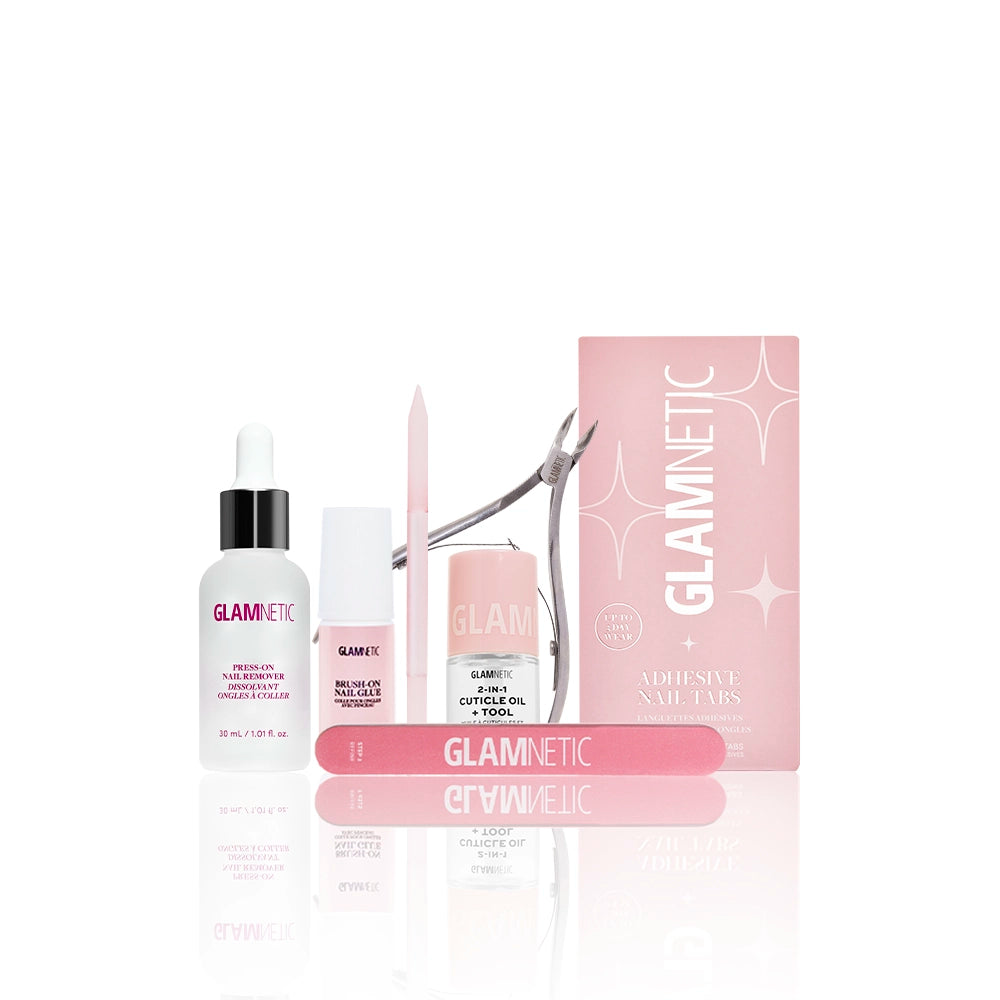 The glamnetic Mani Maintenance Kit in pink includes a nail file, cuticle oil, trimmer, buffer, a small pink box, and manicure tools—all cuticle care essentials neatly showcased on a white background. - Product image