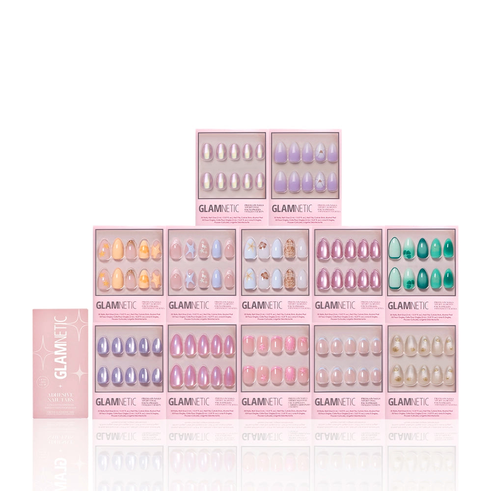 Eleven glamnetic Sirens Cove Collection press-on nail sets in pink boxes are arranged pyramid-style, with a closed box on the left. The sets feature pastels, nudes, patterns, and bold 3D nail art designs. - Product image