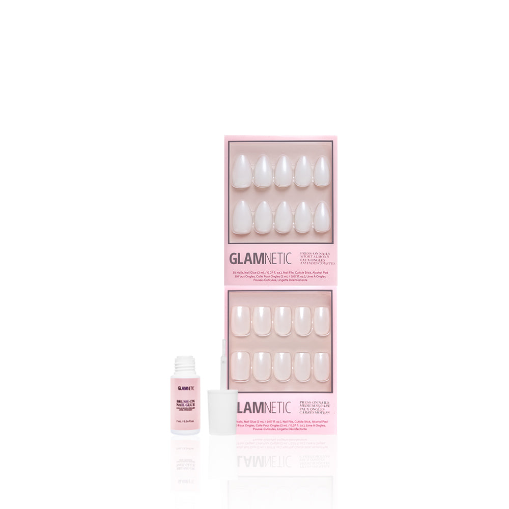 Two pink boxes of glamnetic Bailey + Hailey press-on nails are shown on a white background, displaying white, short almond-shaped, oval nails with a small open bottle of nail glue in front. - Product image