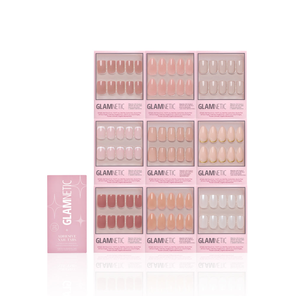 Ten boxes of glamnetic Timeless Tones Collection press-on nails in neutral pinks, nudes, and beiges are arranged in a grid on a white background, with a pink glamnetic booklet placed to the left. - Product image