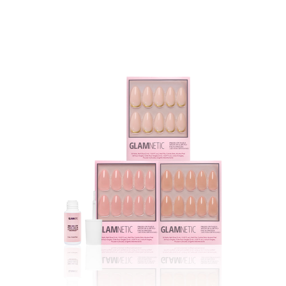 Three boxes of glamnetics The Almond Edit press-on nails are stacked in a pyramid. In front, an open bottle of glamnetic nail glue highlights feminine elegance against a white background. - Product image