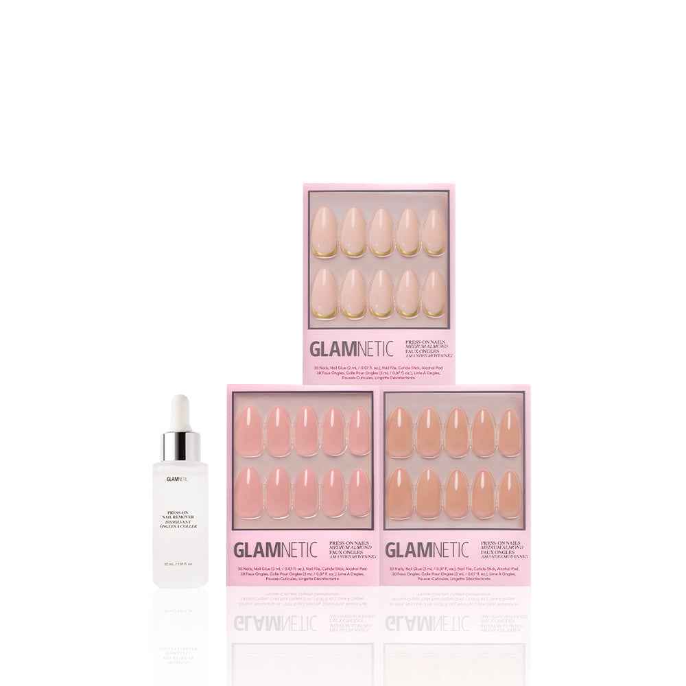 Three boxes of glamnetic’s The Almond Edit medium almond nails in light pink, stacked pyramid-style beside a white dropper bottle of glamnetic nail glue, highlight sheer glossy neutrals and feminine elegance against a white background. - Product image
