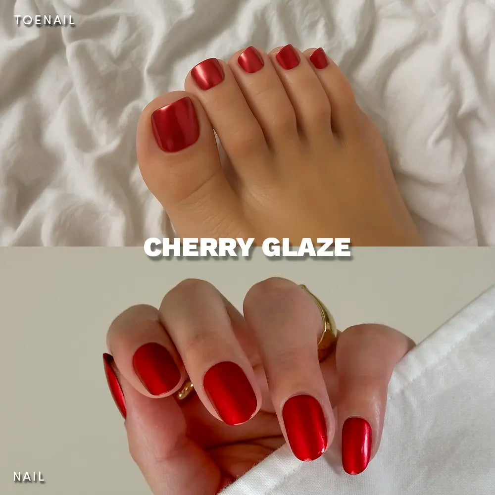 Feet with deep cherry red press-on toenails against a white sheet, paired with glossy red short oval nails on the hands. - Product image