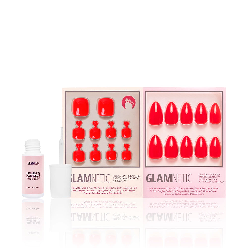 Glamnetic Fiery Red Mani & Pedi set shown with pink brush-on nail glue. Includes bright red press-on nails and toes with high-gloss finish and dramatic black glitter accents. - Product image