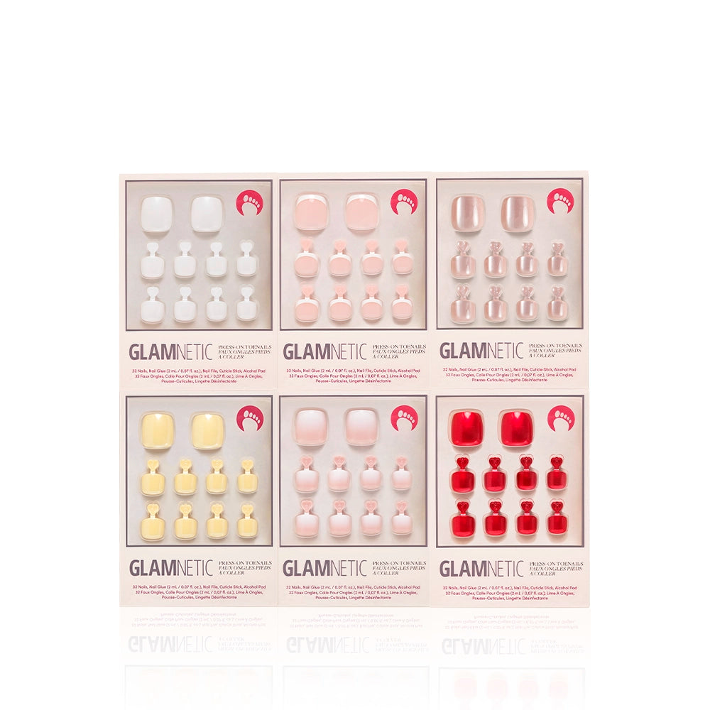 Glamnetic Glazed & Glossy Pedi Bundle featuring six press-on toenail kits in glossy and pastel hues, including white, pink, nude, yellow, and red tones. Each set is displayed in sleek rectangular boxes with clear layouts - Product image