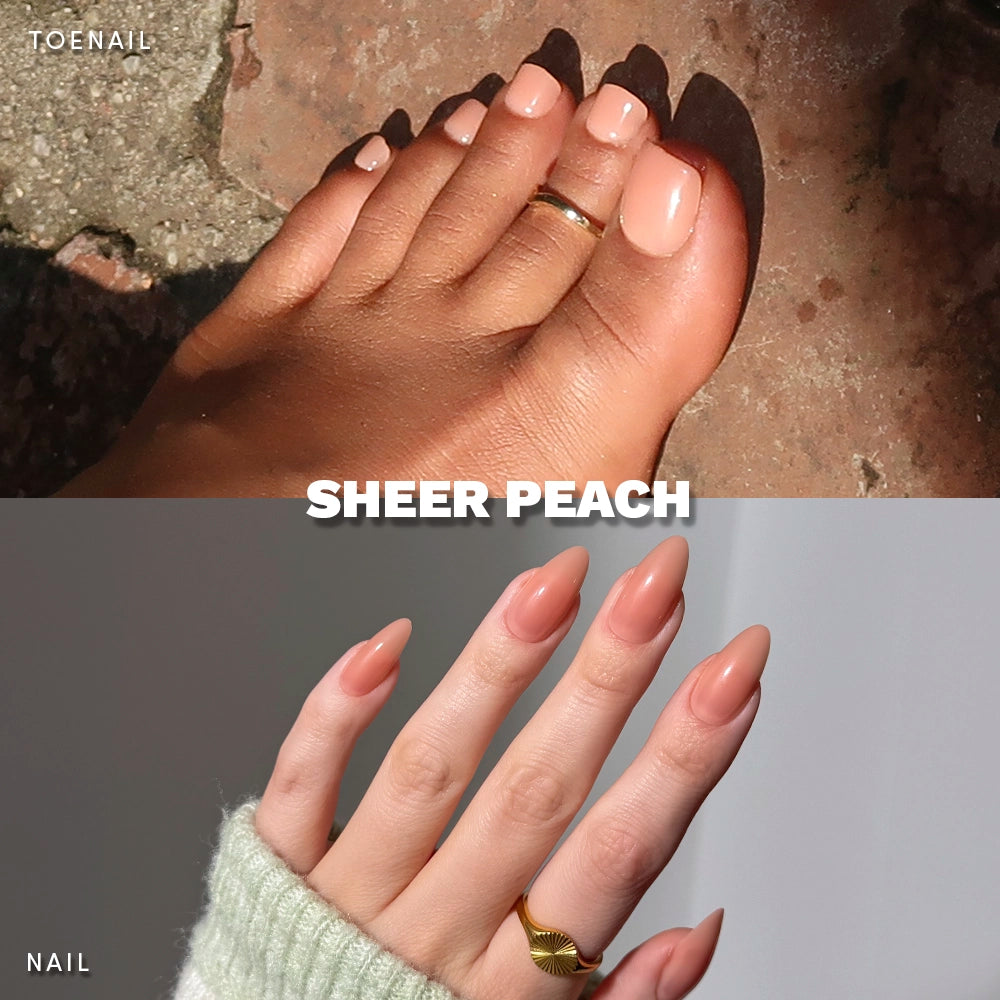 Sheer Peach Mani & Pedi bundle by Glamnetic shown on real hands and feet. Features soft peach-toned press-on nails and toes with a glossy finish, styled with gold rings and cozy, casual settings. - Product image