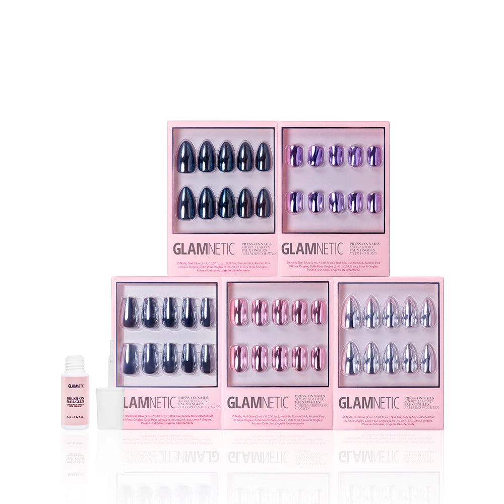 Six boxes of glamnetic The Driver’s Seat: Founder’s Edit press-on nails, featuring metallic chrome shades in blue, purple, and pink, are arranged in two rows with a small nail glue bottle to the left on a white background. - Product image