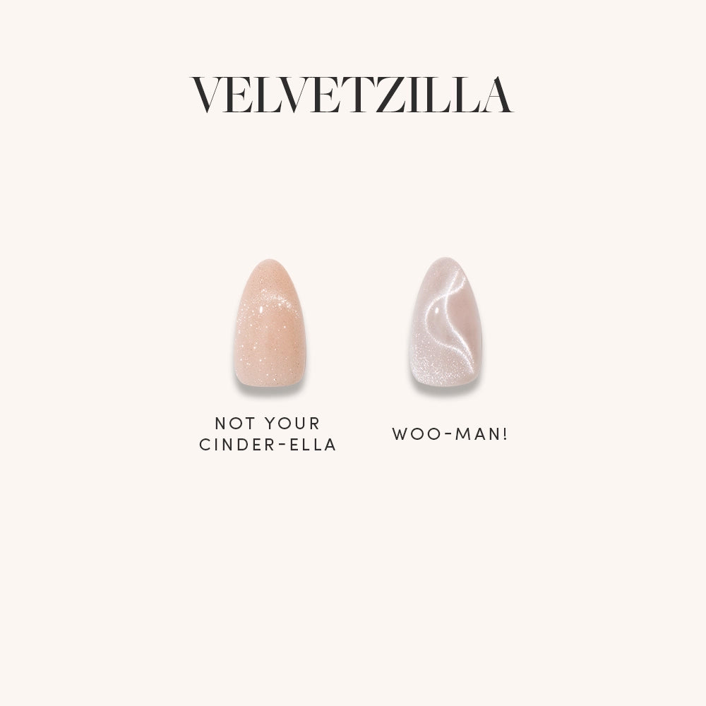 Minimalist display of two individual press-on nail designs from the Glamnetic x Glamzilla ‘Velvetzilla’ set. ‘Not Your Cinder-Ella’ has a peach nude shimmer finish, and ‘Woo-Man!’ features a pearly velvet swirl. Title reads ‘VELVETZILLA.’