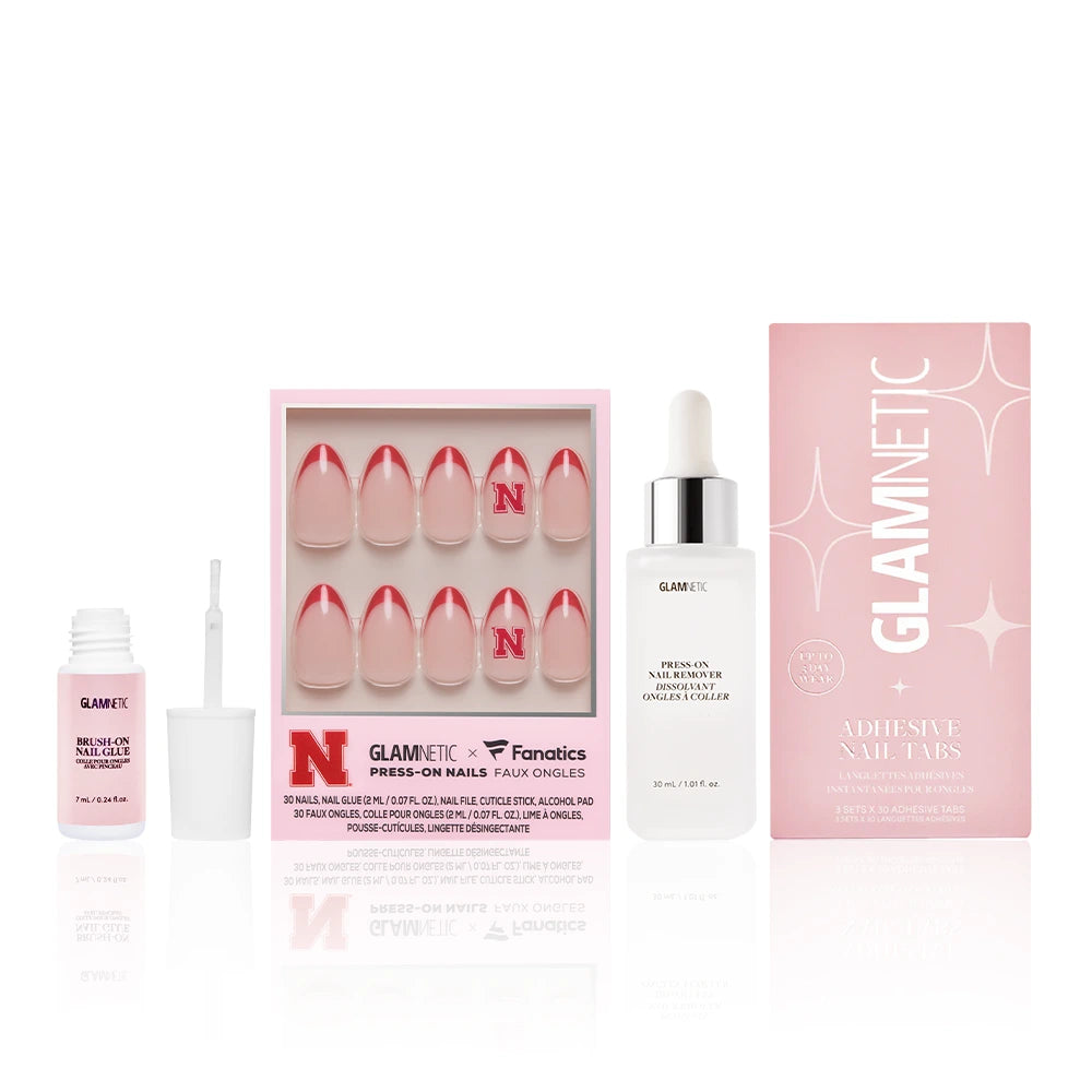 Glamnetic’s The Nebraska Cornhuskers Gameplan kit includes pink and white press-on nails with Husker-red French tips, plus adhesive, nail glue, Press-on nail remover, and adhesive nail tabs—perfect for game day fans.