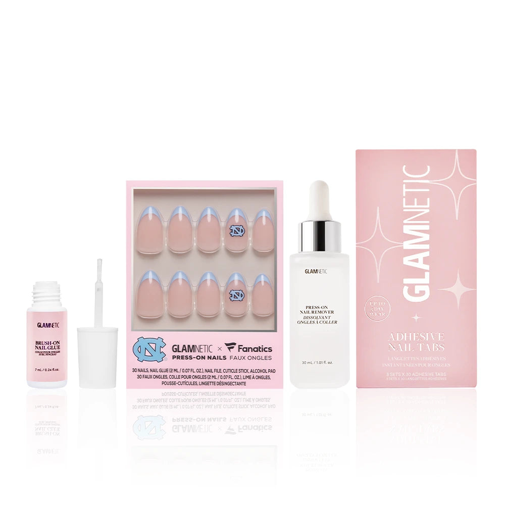 The glamnetic North Carolina Tar Heels Gameplan set includes Carolina-blue French tip press-on nails, nail glue with a brush, Press-on nail remover, and Adhesive Nail Tabs in a pink box, displayed on a white background. - Product image