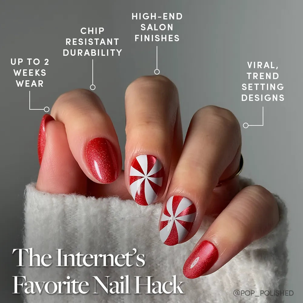 A hand with manicured red nails, two adorned with a peppermint swirl, showcases Candy Crush by glamnetic—featuring up to 2 weeks’ wear, chip-resistant durability, high-end salon finishes, and viral trend-setting designs. - Product image