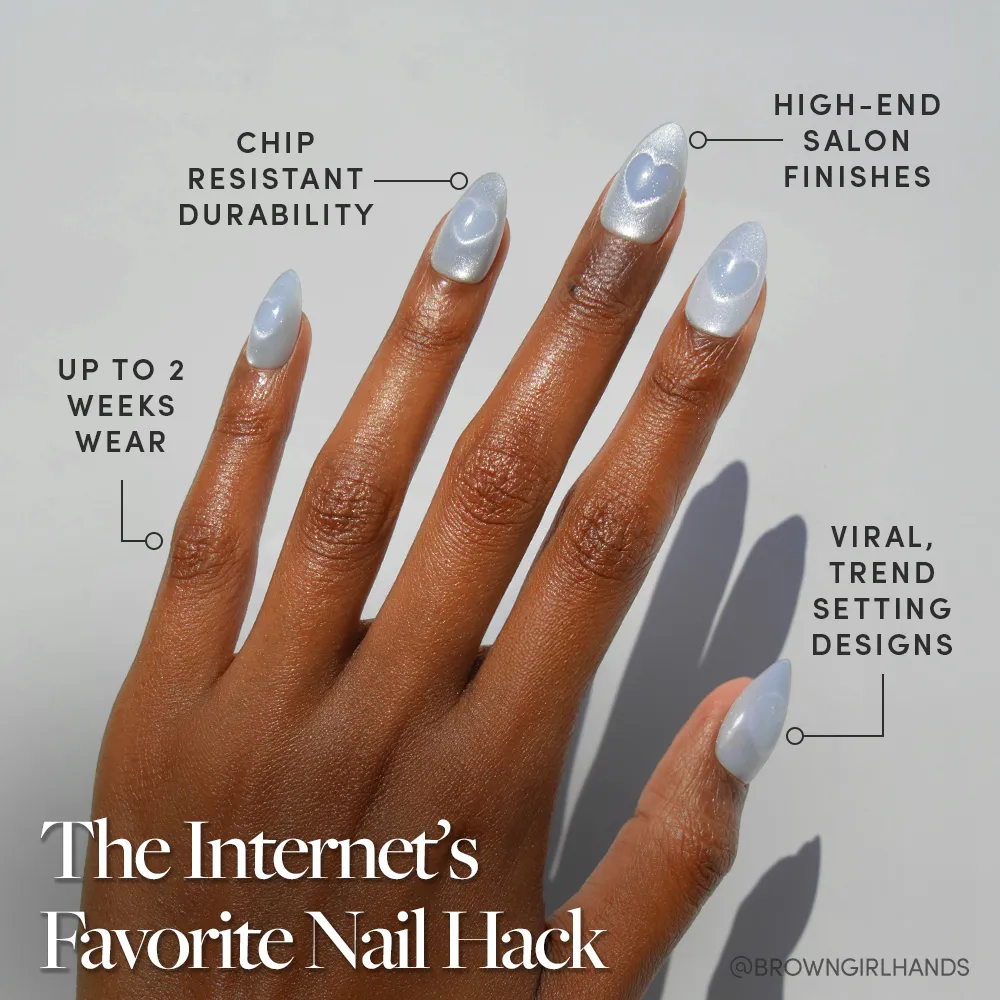 A hand displays long, shiny, light blue Cold Hearted nails from glamnetic with rounded tips against a gray background. Text highlights their salon-quality finish, trendy design, durability, and wear of up to two weeks. - Product image