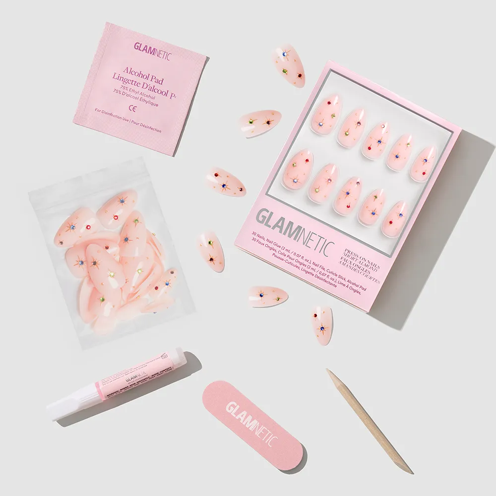 The glamnetic North Star pink press-on nail set features floral almond nails and comes with extra nails, alcohol pad, nail glue, pink nail file, and a wooden cuticle stick—ideal for festive holiday nails!. - Product image