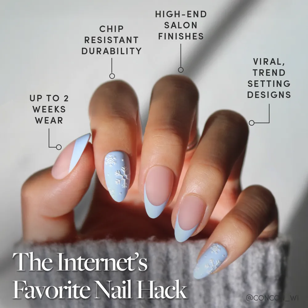 A hand with long matte almond nails wears the glamnetic Snow Bunny set, featuring pastel blue French tips and snowflake designs—enjoy up to 2 weeks' chip-resistant wear and a high-end, viral winter look. - Product image