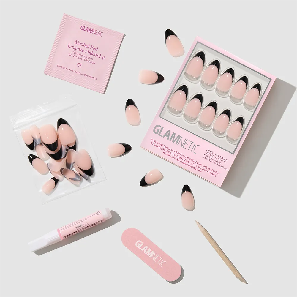 Glamnetic's Caviar Press-On Nails set includes short almond-shaped nails with a pink base and black French tips, plus glue, alcohol pad, nail file, and extra nails—all shown on a white background. - Product image